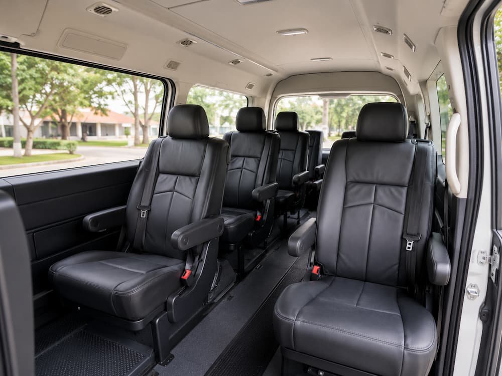 Interior Hiace Premio dengan captain seat, legroom, seatbelt, dan AC vent